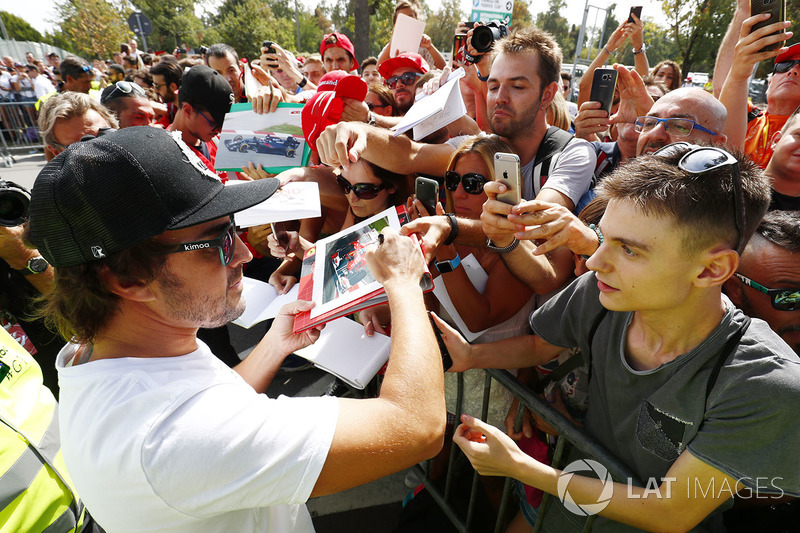 Fernando Alonso, McLaren, signs autographs for his fans