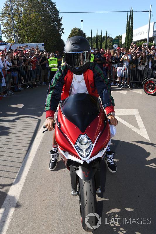 Lewis Hamilton, Mercedes AMG F1 arrives at the track on his motorbike