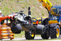 The damaged Romain Grosjean Haas F1 Team VF-18 is removed from the circuit by marshals