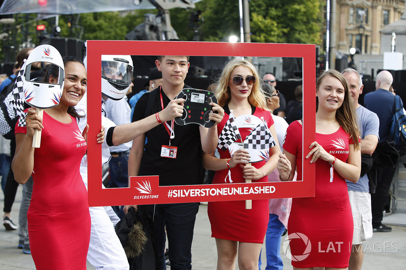 A young fan has his photo taken, some Grid Girls