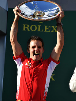Inaki Rueda, Ferrari Race Strategist celebrates with the trophy on the podium