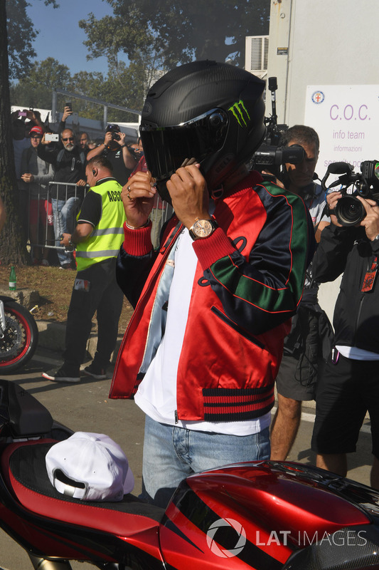Lewis Hamilton, Mercedes AMG F1 arrives at the track on his motorbike