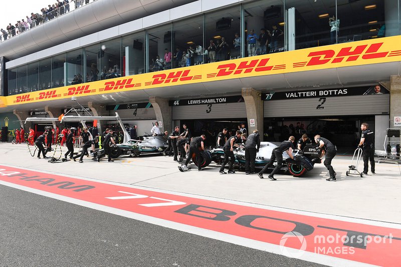 Lewis Hamilton, Mercedes AMG F1 W10, and Valtteri Bottas, Mercedes AMG W10, in the pit lane during Qualifying