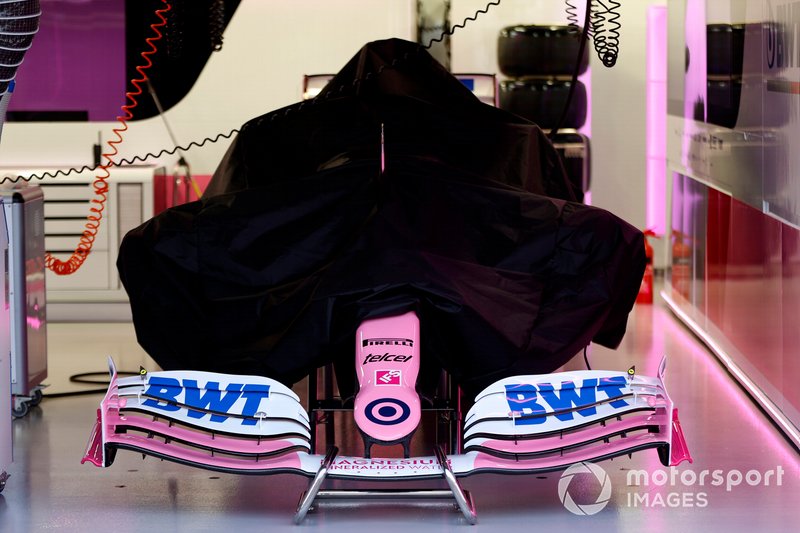 A Racing Point RP20 under covers in the garage