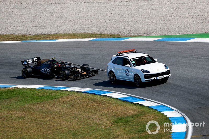 The car of Kevin Magnussen, Haas F1 Team VF-19, is towed back to the garages
