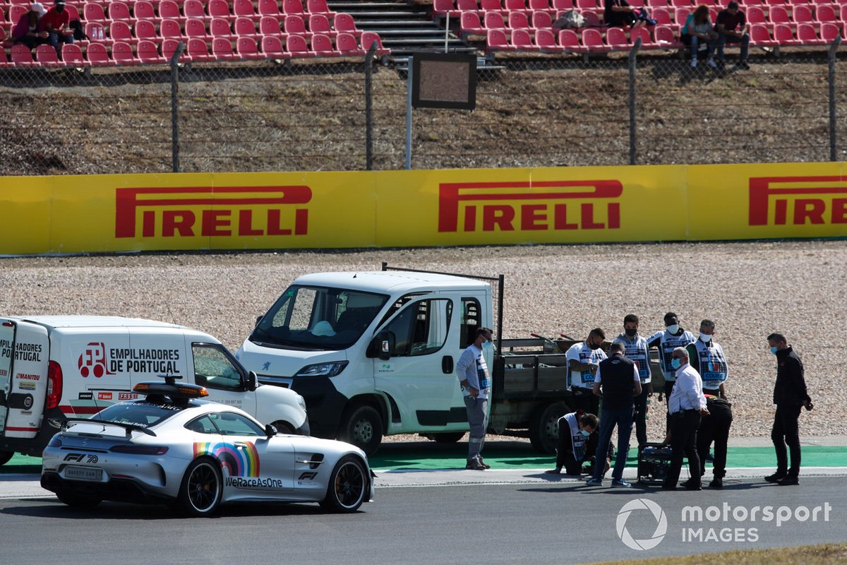 Michael Masi, Race Director, marshals and FIA personnel on track inspecting a loose drain