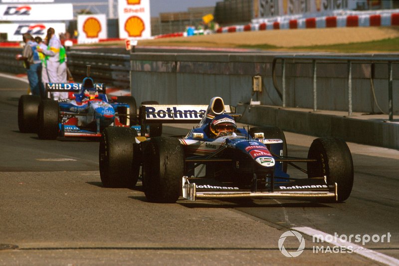 Jacques Villeneuve, Williams FW19 Renault arrives at parc ferme, Jean Alesi, Benetton B197 Renault behind