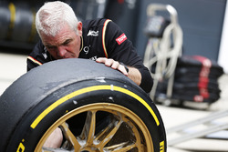 A Lotus team member works on the 18 inch wheels