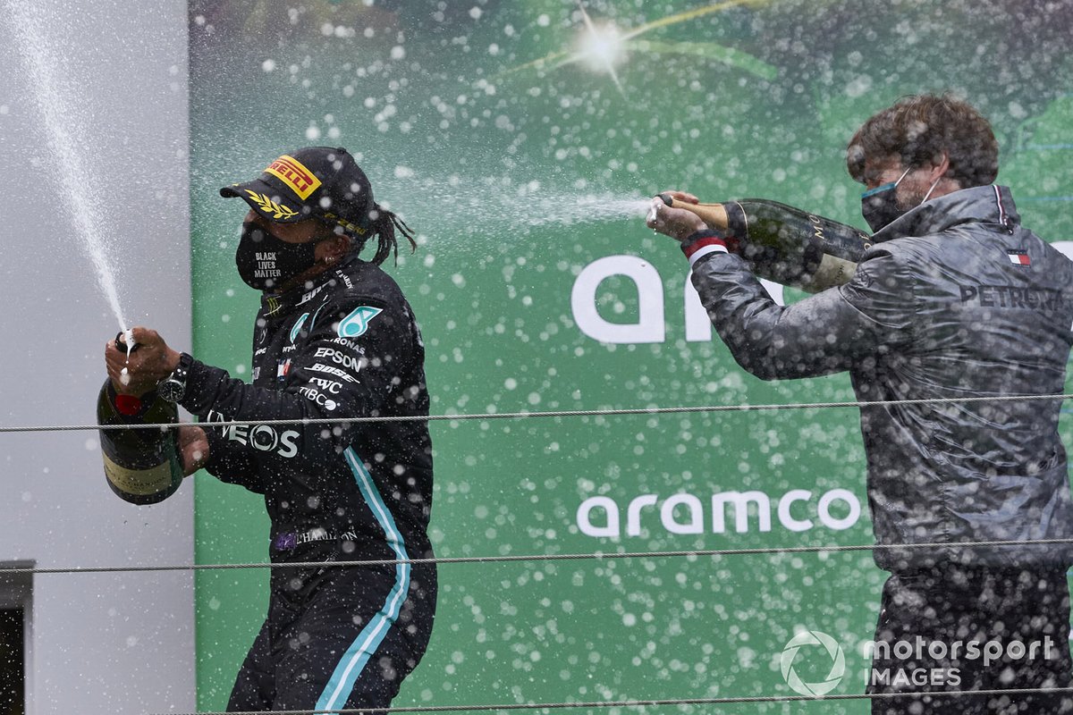 Lewis Hamilton, Mercedes-AMG F1, 1st position, and Steven Lord, Mercedes, spray Champagne on the podium