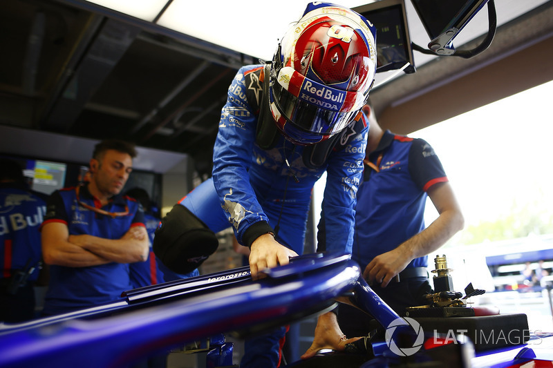 Pierre Gasly, Toro Rosso, enters his cockpit.