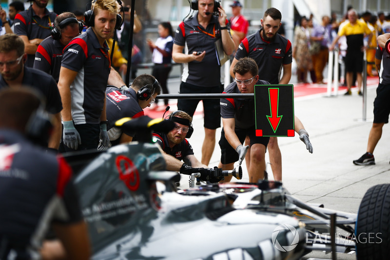 Engineer sat in the cockpit of the Haas F1 Team VF-17 for a practice pit stop