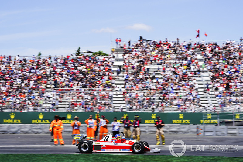Jacques Villeneuve drives the Ferrari 312T3 raced by his father Gilles Villeneuve on a parade lap