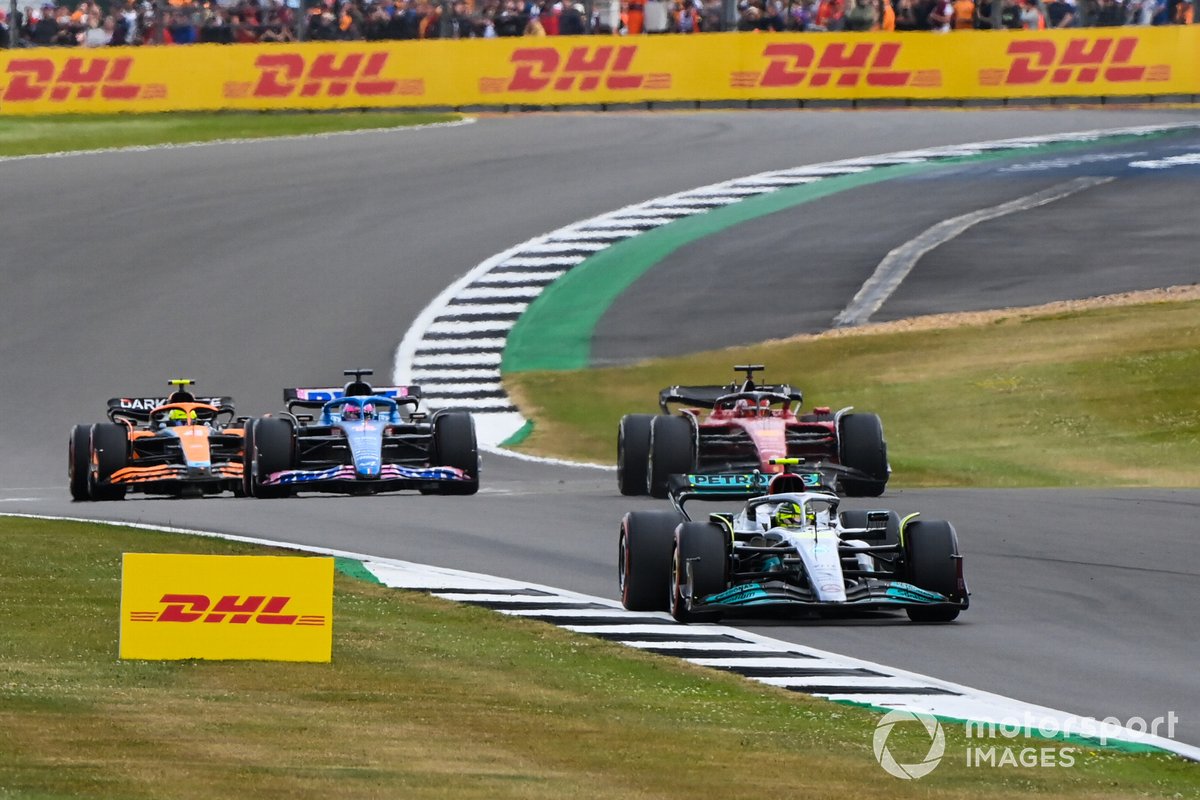 Lewis Hamilton, Mercedes W13, leads Charles Leclerc, Ferrari F1-75, Fernando Alonso, Alpine A522, and Lando Norris, McLaren MCL36
