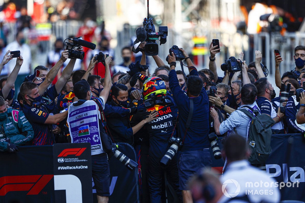 Sergio Perez, Red Bull Racing, 1st position, celebrates with his team in Parc Ferme