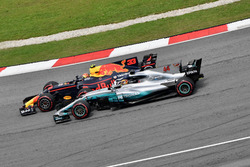 Max Verstappen, Red Bull Racing RB13 passes Lewis Hamilton, Mercedes-Benz F1 W08 for the lead