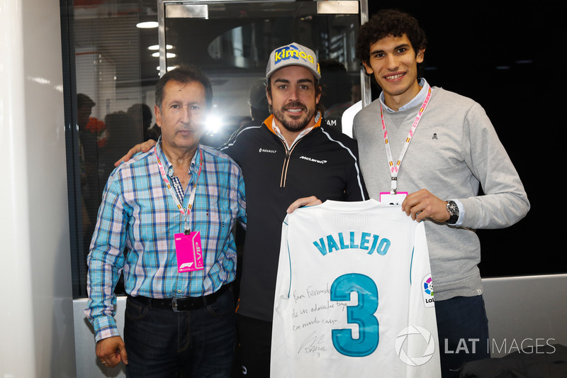 Fernando Alonso, McLaren, receives a signed football shirt from Real Madrid player Jesus Vallejo