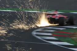 Sparks fly from the car of Sebastian Vettel, Ferrari SF70H