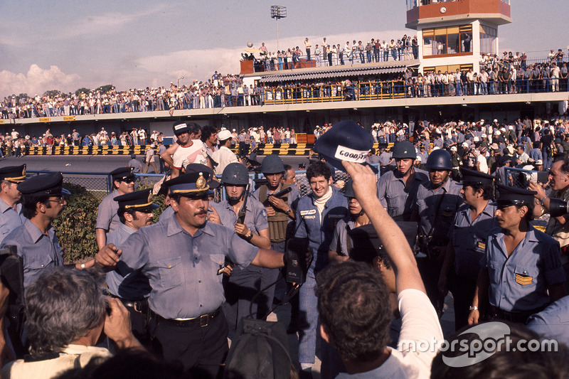 Yarış galibi Jody Scheckter, Wolf Ford ve güvenlik görevlileri