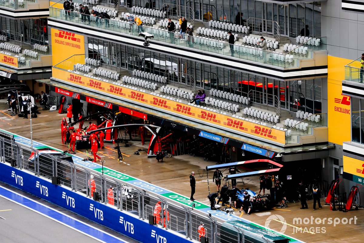 Carlos Sainz Jr., Ferrari SF21, and Fernando Alonso, Alpine A521, in the pit lane