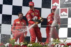 The podium: champagne for race winner Rubens Barrichello, Michael Schumacher and Jean Todt