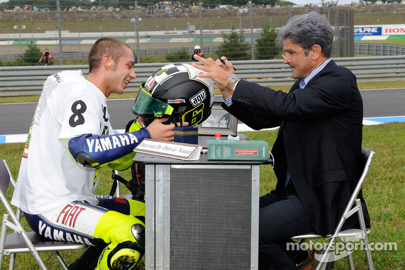 Race winner and 2008 World Champion Valentino Rossi signs and authenticates his helmet