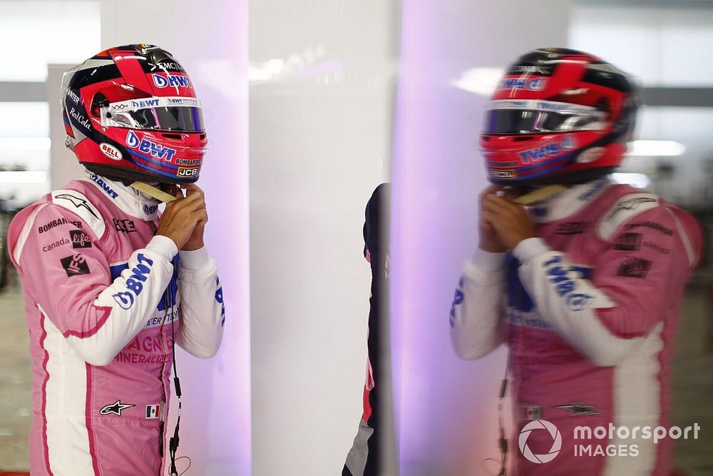 Sergio Perez, Racing Point, straps his helmet on