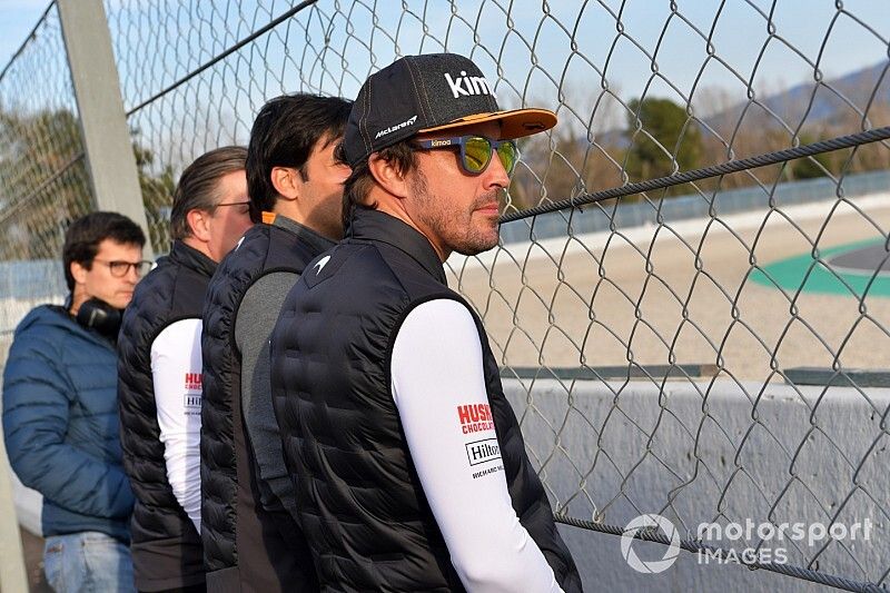 Fernando Alonso watches the action trackside