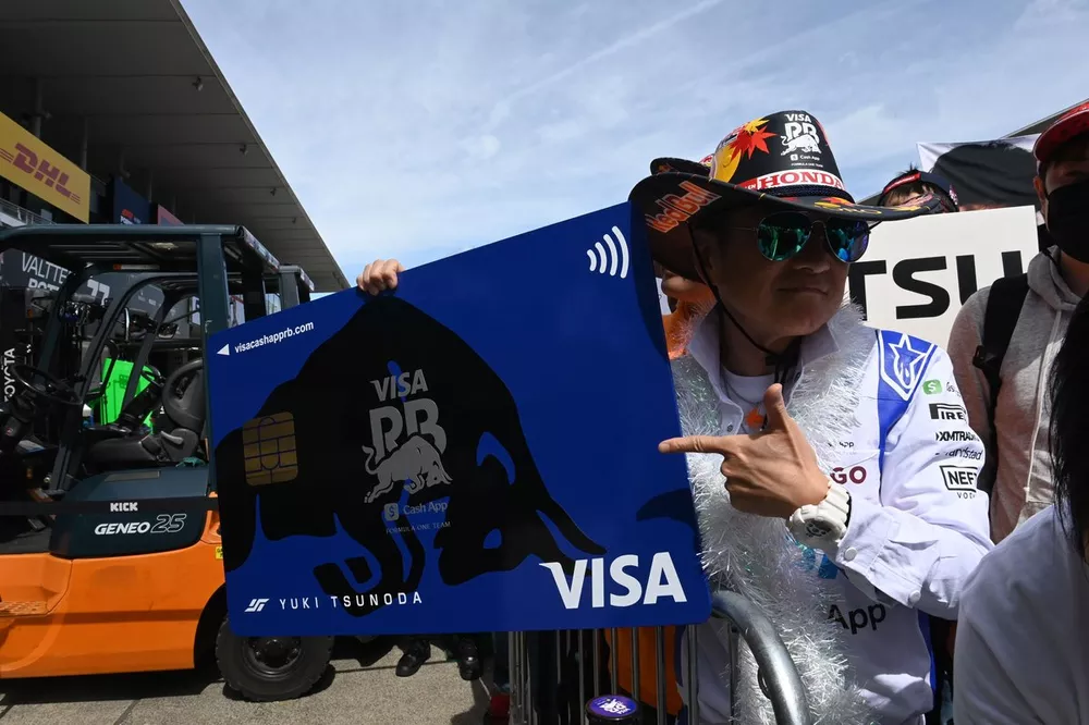 Fans supporting Yuki Tsunoda, Visa Cash App RB F1 Team, in the pit lane