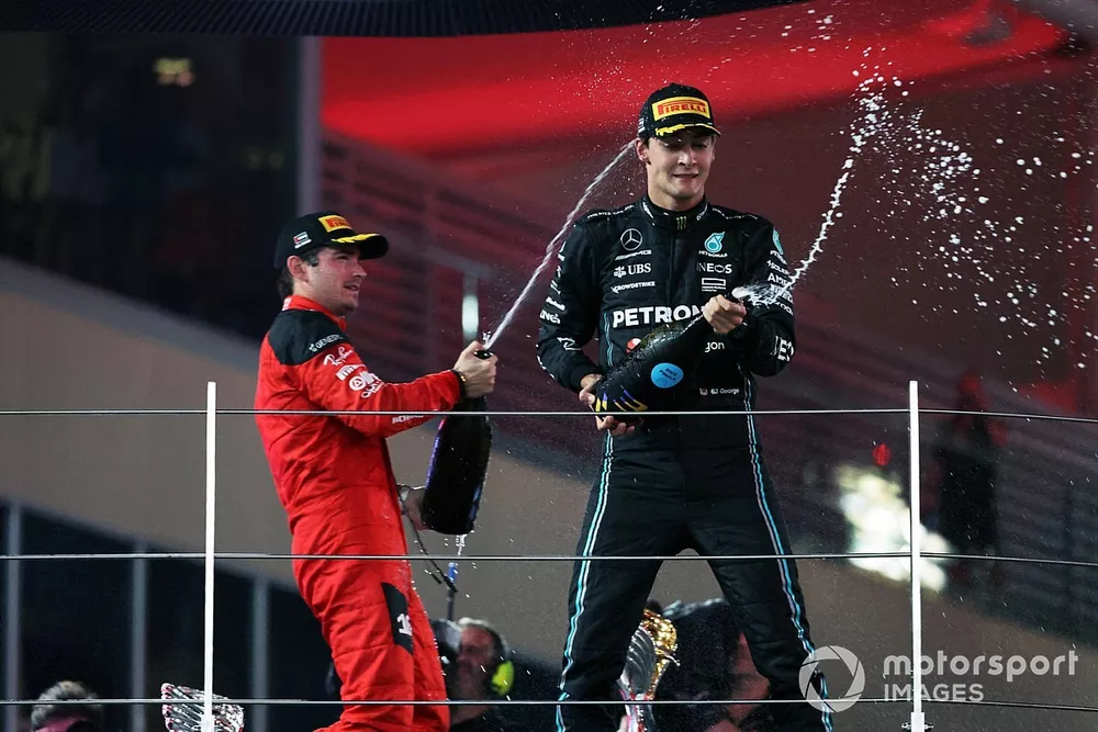 Charles Leclerc, Scuderia Ferrari, 2nd position, George Russell, Mercedes-AMG, 3rd position, spray Champagne on the podium