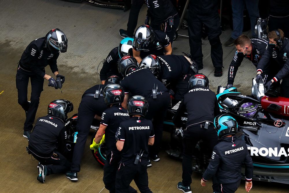 The Mercedes pit crew work on the front wing of Lewis Hamilton, Mercedes W12, in the pit lane