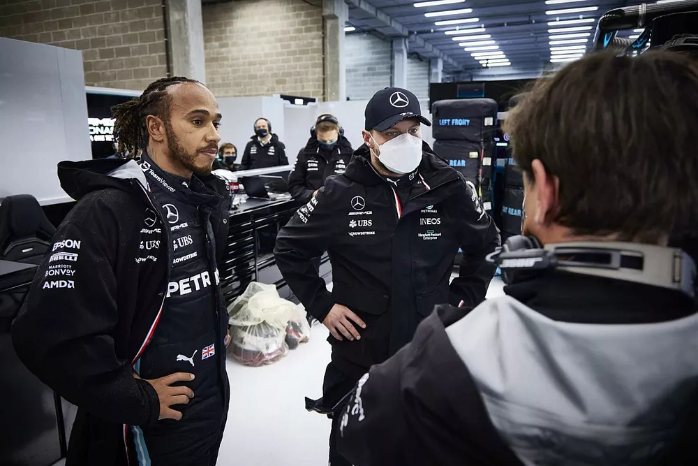 Lewis Hamilton, Mercedes, and Valtteri Bottas, Mercedes, talk with Toto Wolff, Team Principal and CEO, Mercedes AMG, in the garage