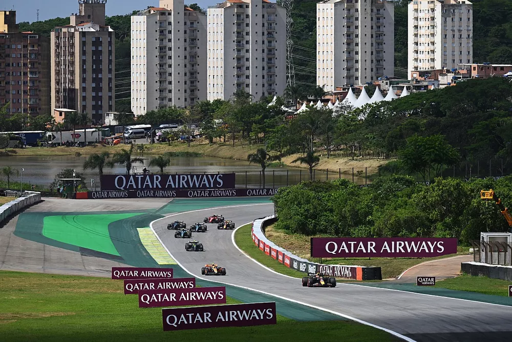 Max Verstappen, Red Bull Racing RB19, leads Lando Norris, McLaren MCL60, and Sir Lewis Hamilton, Mercedes F1 W14