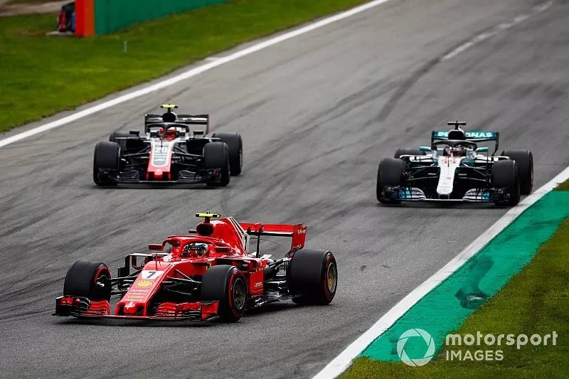 Kimi Raikkonen, Ferrari SF71H, leads Lewis Hamilton, Mercedes AMG F1 W09, and Kevin Magnussen, Haas F1 Team VF-18