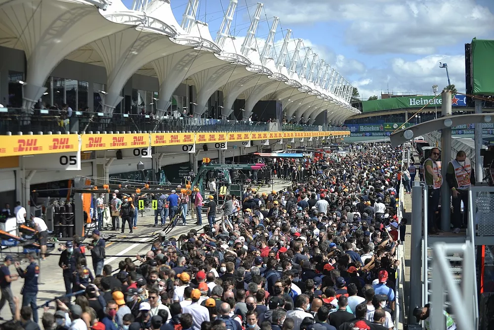 Fans walk through the pit lane