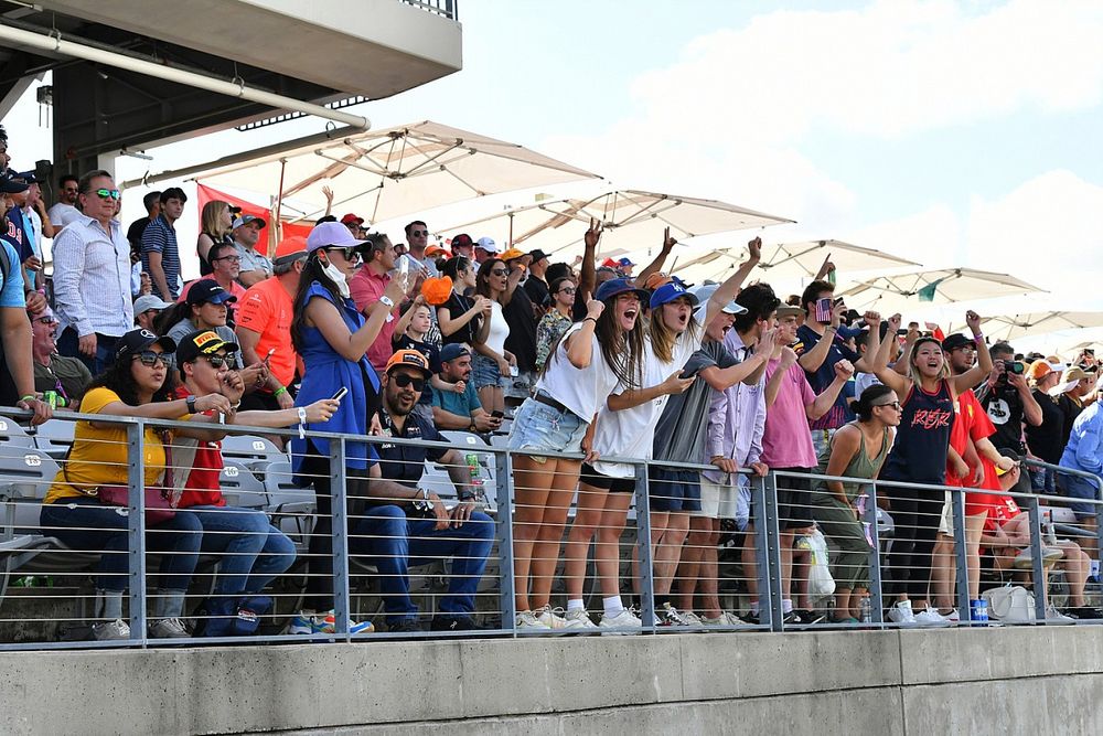 Fans cheer from a grandstand
