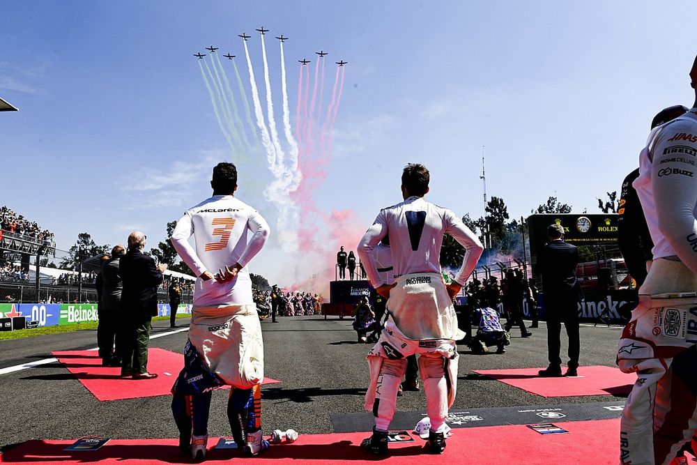 Daniel Ricciardo, McLaren, and Pierre Gasly, AlphaTauri, look on as the Mexican Air Force fly over the grid in 9 Pilatus PC-7's prior to the start