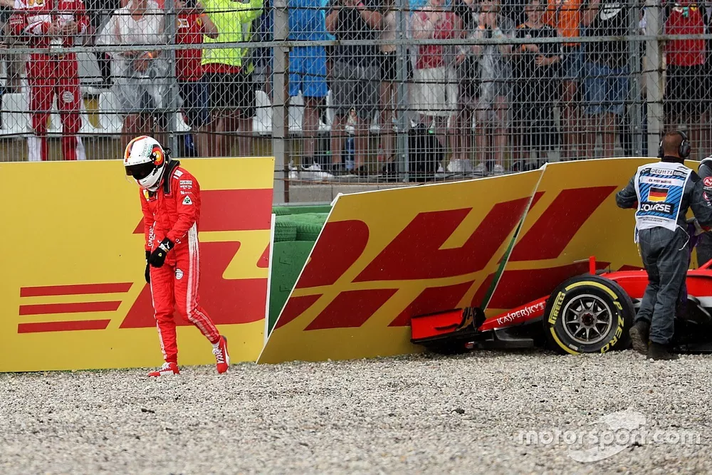 Sebastian Vettel, Ferrari SF71H walks in after crashing out of the race