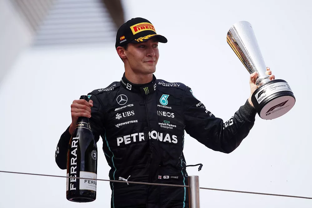 George Russell, Mercedes-AMG, 3rd position, on the podium with his trophy and Champagne 