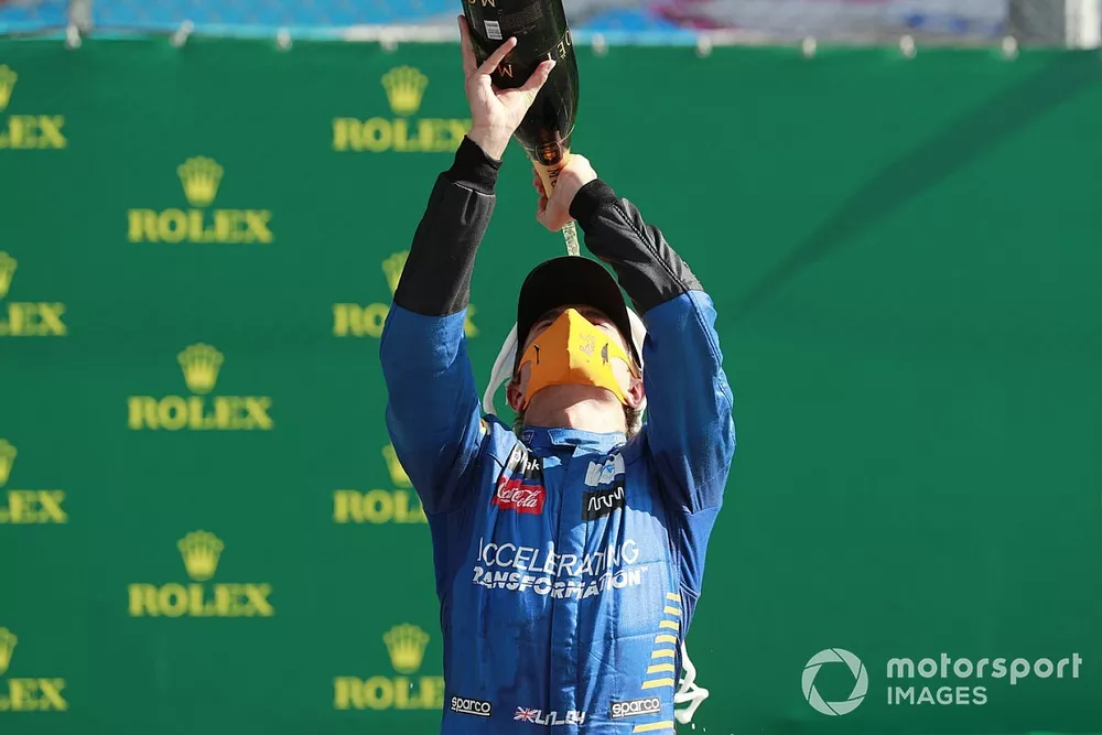 Lando Norris, McLaren, sprays the champagne on the podium