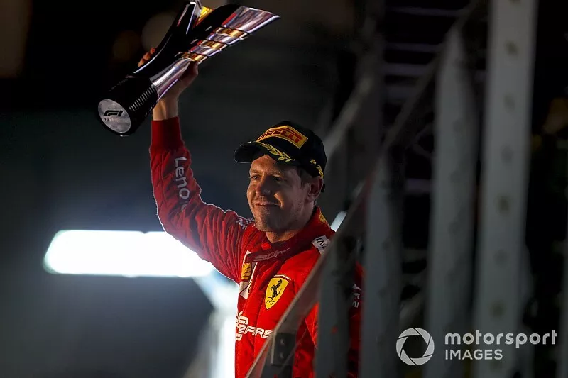 Race winner Sebastian Vettel, Ferrari celebrates with the trophy