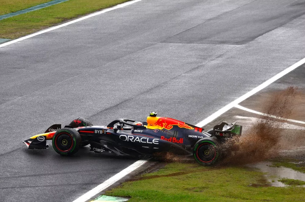 Sergio Perez, Red Bull Racing RB20, sprays mud as he tries to rejoin after a spin