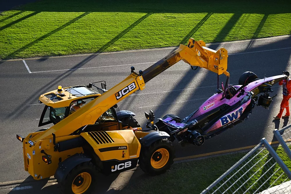 Los comisarios retiran el coche da&ntilde;ado de Esteban Ocon, Alpine A523, del circuito con una JCB