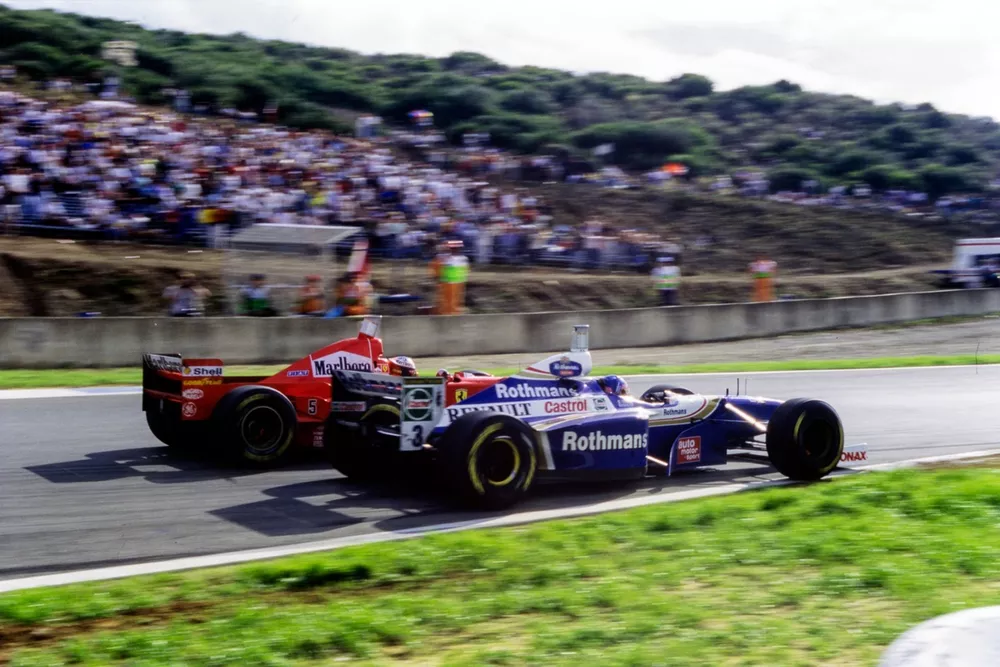 The controversial collision between Michael Schumacher, Ferrari F310B, and Jacques Villeneuve, Williams FW19 Renault