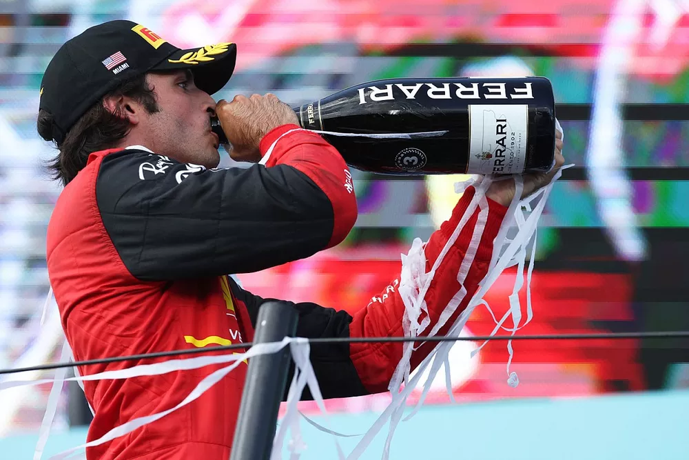 Carlos Sainz, Ferrari, 3rd position, celebrates on the podium with Champagne