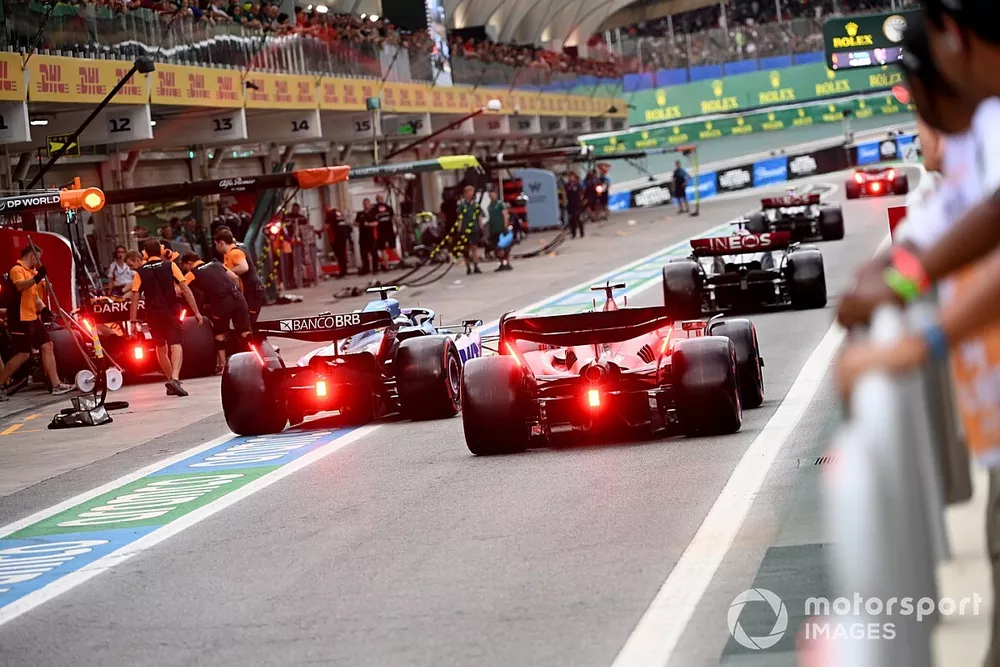 George Russell, Mercedes F1 W14, Pierre Gasly, Alpine A523, Charles Leclerc, Ferrari SF-23, in the pit lane