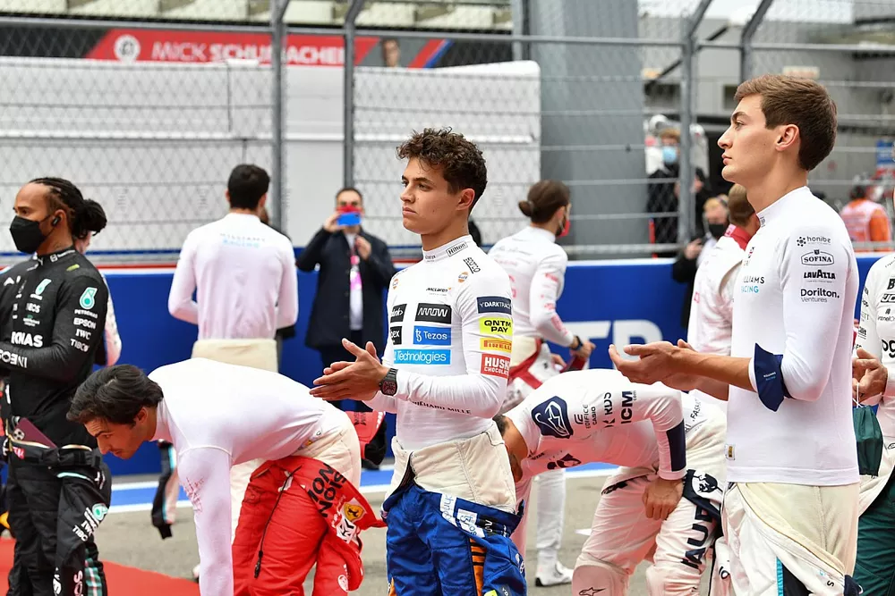 Lewis Hamilton, Mercedes, Carlos Sainz Jr., Ferrari, Lando Norris, McLaren, and George Russell, Williams, on the grid prior to the start