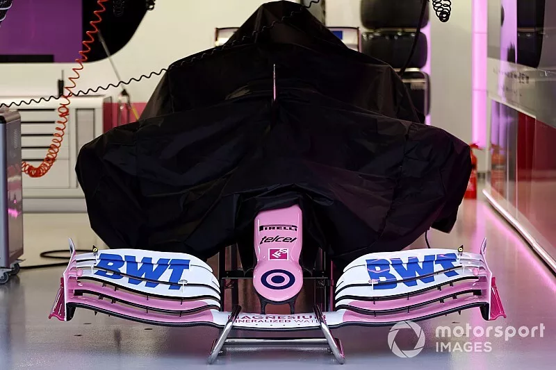 A Racing Point RP20 under covers in the garage