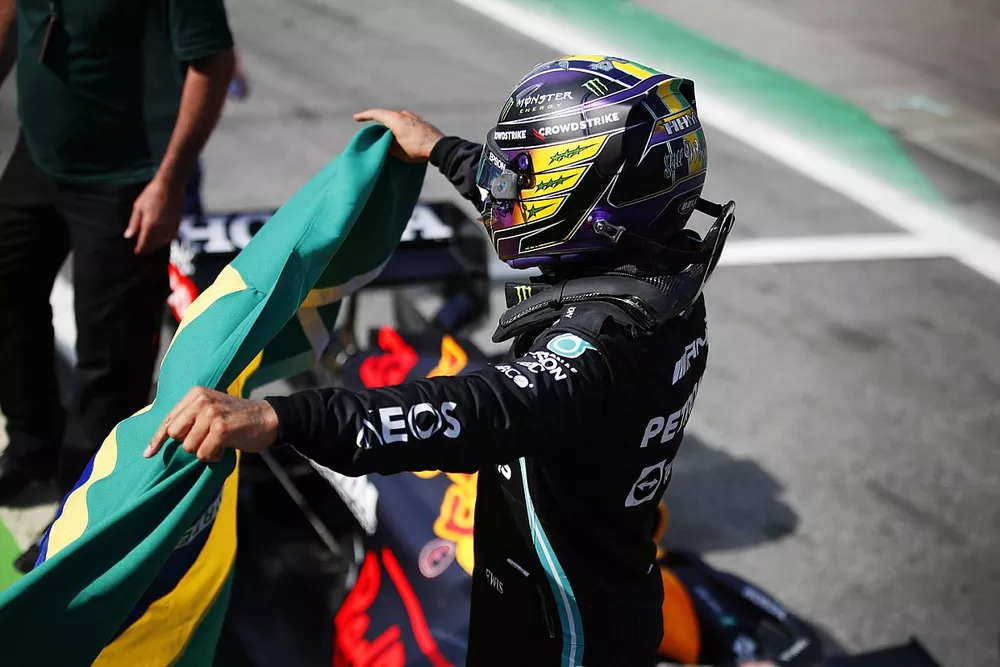 Lewis Hamilton, Mercedes, 1st position, celebrates in Parc Ferme with a Brazilian flag
