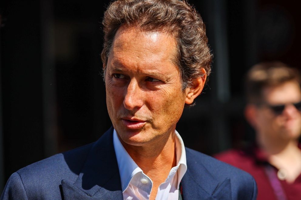 Ferrari chairman John Elkann looks on in the paddock.