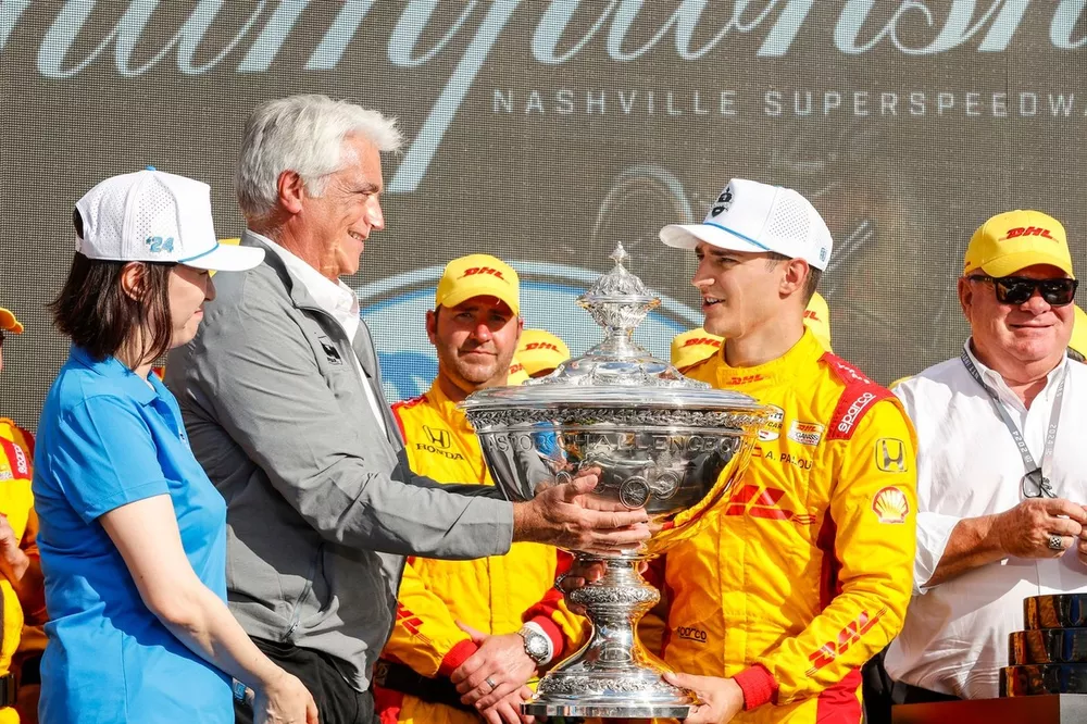 Alex Palou, Chip Ganassi Racing Honda is presented the Astor Challenge Cup for winning the 2024 IndyCar championship by Mark Miles and NTT SVP, Head of Public Relations Makiko Sekine
